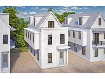 Charming three-story beach house with white siding, a small porch, and light-blue door at 26 Nats Ct, Charleston, SC 29403