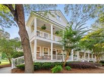 Charming two-story home features double porches, lush landscaping, and inviting curb appeal at 3000 Treadwell St, Mount Pleasant, SC 29466