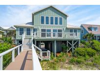 Charming coastal home with a beach access walkway, showcasing an elevated design and serene surroundings at 313 E Arctic Ave, Folly Beach, SC 29439