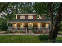 Charming two-story home featuring a wide front porch with white railings and brick accents at 49 Crosscreek Dr, Charleston, SC 29412