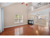 Bright living room featuring a fireplace and hardwood floors, providing a warm, inviting space at 8743 Grassy Oak Trl, North Charleston, SC 29420