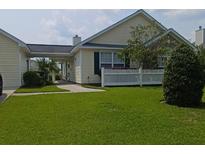 Charming single-story home with a well-manicured lawn and a white picket fence at 103 Savannah River Dr, Summerville, SC 29485