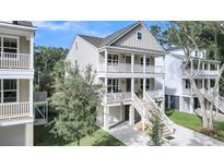Charming two-story home with double balconies and well-manicured lawn at 1304 Lieben Rd, Mount Pleasant, SC 29466