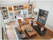 Open living room featuring vaulted ceiling, built-in bookshelves, wet bar and comfortable seating arrangement at 1511 Fairway Dr, Charleston, SC 29412