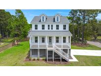 Charming two-story coastal home with a welcoming front porch and manicured lawn at 1577 Periwinkle Dr, Mount Pleasant, SC 29466