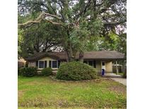 Charming single-story home featuring a lush, mature shade tree and covered parking at 1601 Westmoreland Ave, Charleston, SC 29412