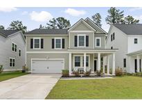 Charming two-story home with a well-manicured lawn and a welcoming front porch at 174 Red Bluff St, Summerville, SC 29483