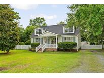 Charming cape cod with dormers, white picket fence, mature landscaping at 19 Avondale Ave, Charleston, SC 29407