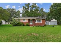 Charming brick home featuring a well-manicured lawn and a classic design at 2708 Mawood Ave, North Charleston, SC 29406