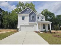 New two-story home with a two-car garage and a manicured front yard at 410 Cadbury Loop, Summerville, SC 29486