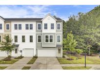 Charming townhome with a two-car garage, complemented by tasteful landscaping and a welcoming entrance at 422 Caledon Ct, Johns Island, SC 29455