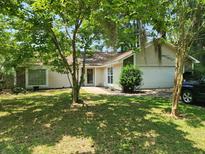 Charming home with a well-manicured lawn, mature trees, and a welcoming facade at 514 Woodward Blvd, Summerville, SC 29483
