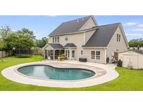 Inviting backyard with a beautiful pool and well-maintained lawn, perfect for outdoor enjoyment at 5289 Mulholland Dr, Summerville, SC 29485