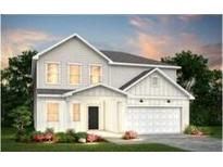 Charming two-story home featuring a crisp white exterior, well-manicured lawn and a two car garage at 724 Meadowbrook Ln, Summerville, SC 29486