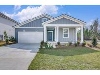 Charming home with gray siding, white trim, inviting front porch, and a well-maintained front lawn at 778 Meadowbrook Ln, Summerville, SC 29486