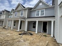 New construction townhomes featuring covered front porches and craftsman-style details at 821 Alma Square Dr, Moncks Corner, SC 29461
