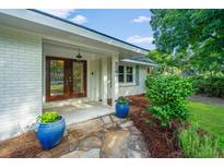 Inviting front entrance features double doors, a stone walkway, and decorative blue planters at 881 Evans Rd, Charleston, SC 29412