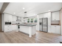 Bright, modern kitchen features stainless steel appliances, an island and white cabinetry at 106 Swanson Dr, Summerville, SC 29483