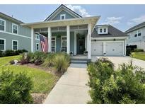 Charming home featuring blue siding, white trim, inviting front porch and a well-manicured front yard at 2221 Generals St, Charleston, SC 29492