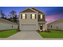 Charming two-story home featuring a two-car garage and well-manicured lawn at 2242 Macallan Blvd, Ravenel, SC 29470