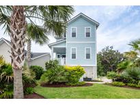 Charming, light blue two-story home with landscaped yard and a lush tropical palm tree in the front at 2734 Battle Trail Dr, Johns Island, SC 29455