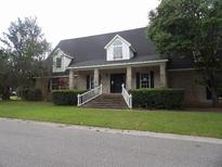 Charming single-story brick home with a covered entrance and well-maintained landscaping at 301 Archibald Dr, Goose Creek, SC 29445