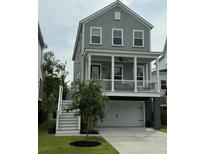 Charming two-story home with a covered porch, gray siding, white trim and a two car garage at 3016 Evening Tide Dr, Hanahan, SC 29410