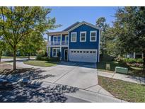Charming blue two-story home featuring a spacious driveway and a welcoming double porch at 3306 Hartwell St, Johns Island, SC 29455