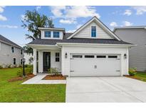 Charming new construction home featuring a two-car garage and a well-manicured lawn at 3806 Grateful Rd, North Charleston, SC 29420