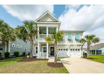 Charming home with a two-story porch, well-manicured lawn, and beautiful palm trees at 415 True North Trail, Summerville, SC 29486