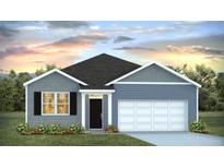 Charming single-story home with a cozy front yard, complemented by blue siding and beautiful landscaping at 5516 Bowmore Blvd, Ravenel, SC 29470