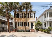 Charming two-story home with black shutters and palm trees at 8 Pitt St # A, Charleston, SC 29401