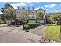 Attractive townhouse featuring palm trees, a private driveway, and an attached garage at 9313 Sweetbay Ct, Ladson, SC 29456