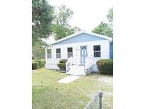 Charming single-story home with a blue door, white trim, and a well-maintained front yard at 104 Grant St, Walterboro, SC 29488