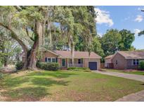 Charming brick home with a lovely, landscaped yard and mature tree in desirable neighborhood at 1102 N Shadow Dr, Mount Pleasant, SC 29464