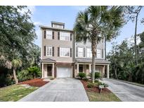 Charming townhome exterior featuring a private driveway and manicured landscaping with mature palm trees at 160 Palm Cove Way, Mount Pleasant, SC 29466