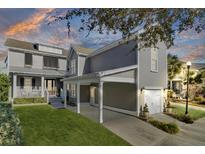 Beautiful two-story home with manicured lawn, covered parking and mature landscaping at 1615 Paradise Lake Dr, Mount Pleasant, SC 29464