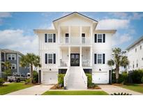 Stunning two-story white home with black shutters, double garages, palm trees and beautiful lawn at 1714 Fort Palmetto Cir, Mount Pleasant, SC 29466