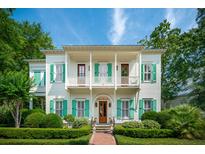 Charming two-story home with a landscaped front yard and inviting double porches, perfect for relaxing outdoors at 28 Robert Mills Cir, Mount Pleasant, SC 29464