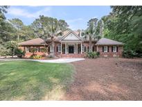 Beautiful brick home with a symmetrical facade, manicured lawn, and mature landscaping at 3555 Colonel Vanderhorst Cir, Mount Pleasant, SC 29466