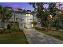 Charming townhomes featuring a driveway and gray siding, creating a welcoming and modern curb appeal at 4067 S Rhett Ave, North Charleston, SC 29405