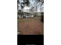 Well-maintained home with a charming front porch and ample yard space at 5423 Buckeye Rd, Hollywood, SC 29449