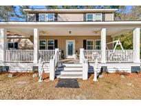 Inviting two-story home featuring a spacious covered front porch with white columns and porch swing at 62 Wexford Way, Walterboro, SC 29488