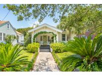 Charming cottage-style home with a landscaped front yard and a cozy, inviting entrance at 66 Darlington Ave, Charleston, SC 29403