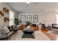 Inviting living room featuring stylish decor, a cozy rug, and ample natural light at 8938 Planters Row Ln, Summerville, SC 29485