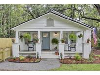 Charming cottage featuring rocking chairs and hanging plants on the welcoming front porch at 920 Simmons Ave, Summerville, SC 29483