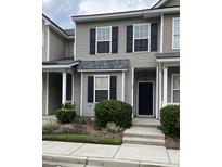 Two-story townhome featuring muted green siding, black shutters, and a well-maintained landscaped front yard at 126 Woodward Rd, Goose Creek, SC 29445