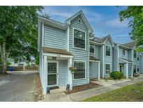Charming townhouse with light blue siding and well-maintained landscaping at 1686 Hunters Run Dr, Mount Pleasant, SC 29464