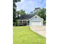 Charming one-story home with blue siding, a well-manicured lawn, and an attached two-car garage at 1928 Gasque St, Johns Island, SC 29455