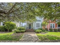 Charming home with a welcoming front porch, a well-manicured lawn, and mature trees at 209 Barberry St, Summerville, SC 29483